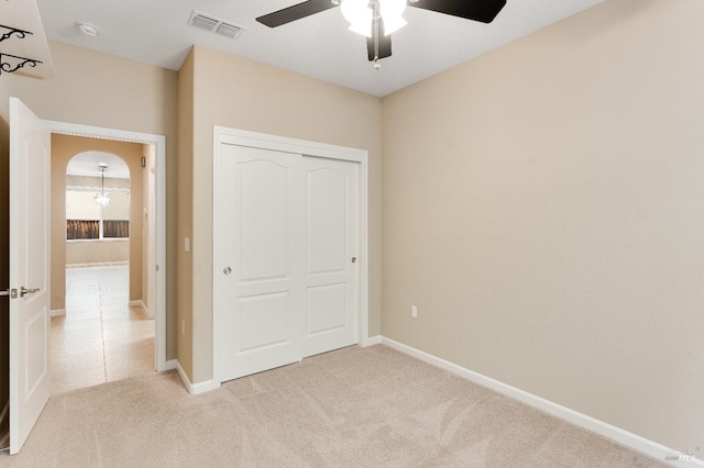 8568 Pinehollow Cir, Discovery Bay, CA 94505 - unfurnished bedroom with light carpet, a closet, baseboards, and arched walkways