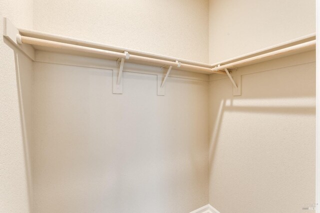 8568 Pinehollow Cir, Discovery Bay, CA 94505 - unfurnished bedroom featuring light carpet, a closet, baseboards, a ceiling fan, and arched walkways