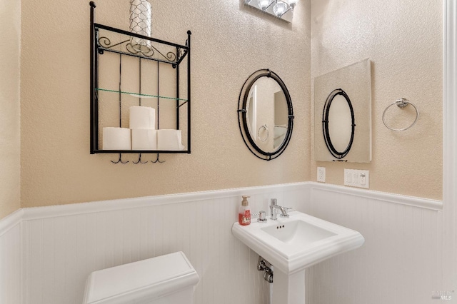 8568 Pinehollow Cir, Discovery Bay, CA 94505 - bathroom with wainscoting, toilet, and a sink