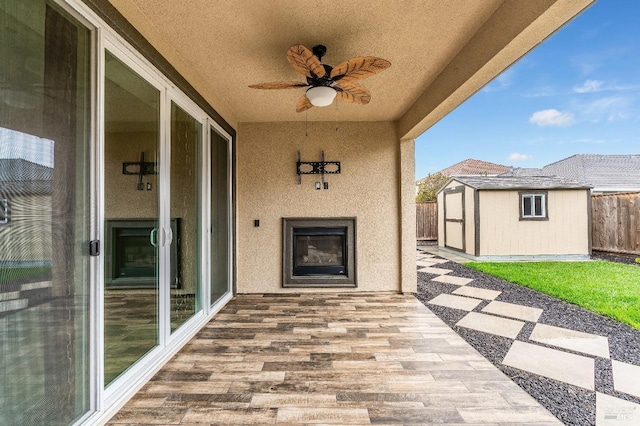 8568 Pinehollow Cir, Discovery Bay, CA 94505 - view of patio with a shed, fence, a ceiling fan, an outbuilding, and a glass covered fireplace