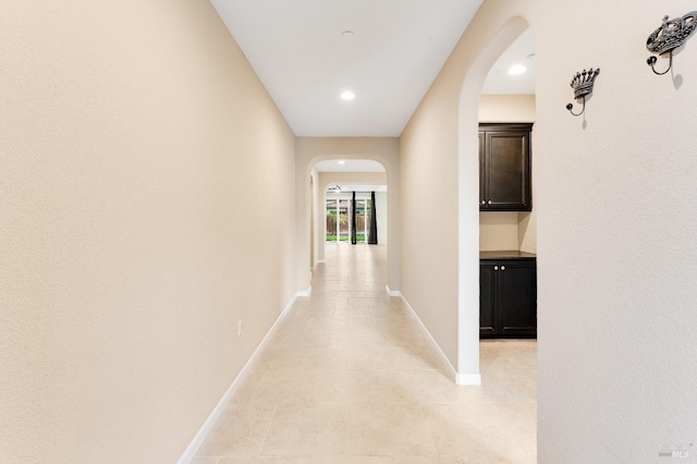 8568 Pinehollow Cir, Discovery Bay, CA 94505 - hallway with arched walkways, baseboards, light tile patterned floors, and recessed lighting