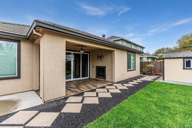 8568 Pinehollow Cir, Discovery Bay, CA 94505 - rear view of house with stucco siding, an outdoor structure, ceiling fan, and a storage shed