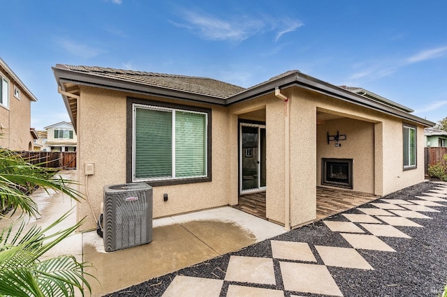 8568 Pinehollow Cir, Discovery Bay, CA 94505 - back of property with central AC unit, exterior fireplace, stucco siding, and fence