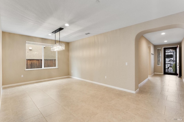 8568 Pinehollow Cir, Discovery Bay, CA 94505 - spare room featuring arched walkways, a chandelier, recessed lighting, baseboards, and light tile patterned floors