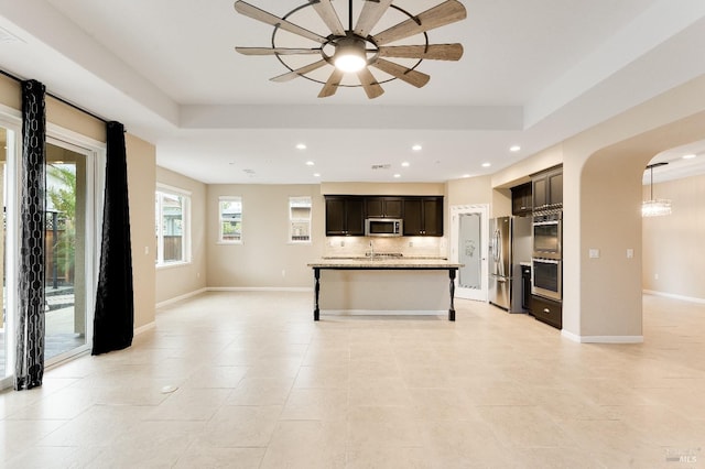 8568 Pinehollow Cir, Discovery Bay, CA 94505 - kitchen with stainless steel appliances, open floor plan, arched walkways, backsplash, and ceiling fan