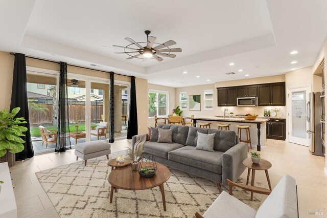 8568 Pinehollow Cir, Discovery Bay, CA 94505 - living area featuring a tray ceiling, ceiling fan, recessed lighting, and light tile patterned floors
