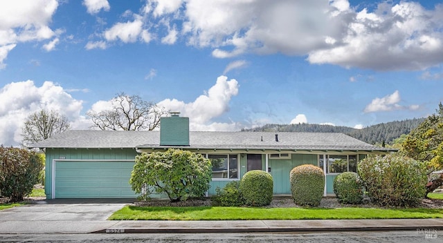 6574 Stone Bridge Rd, Santa Rosa, CA 95409 - single story home with driveway, a garage, and a chimney