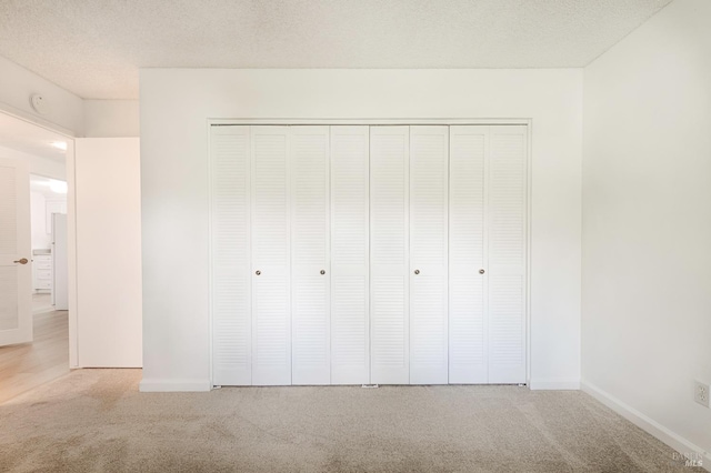 6574 Stone Bridge Rd, Santa Rosa, CA 95409 - unfurnished bedroom featuring baseboards, a closet, carpet flooring, and a textured ceiling