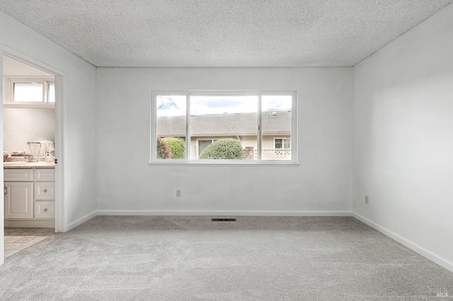 6574 Stone Bridge Rd, Santa Rosa, CA 95409 - unfurnished room featuring a textured ceiling, visible vents, plenty of natural light, and light carpet
