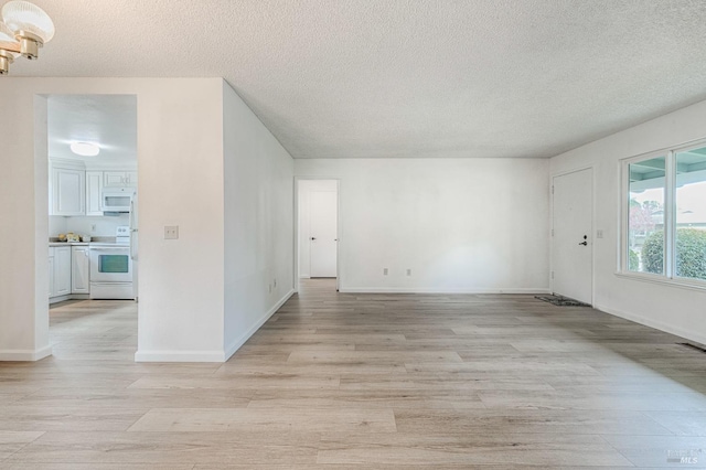 6574 Stone Bridge Rd, Santa Rosa, CA 95409 - interior space featuring a textured ceiling, baseboards, and light wood-type flooring