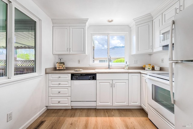 6574 Stone Bridge Rd, Santa Rosa, CA 95409 - kitchen with white appliances, a sink, light wood-style floors, visible vents, and white cabinets