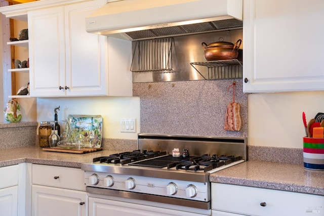 kitchen featuring stainless steel gas cooktop, ventilation hood, open shelves, white cabinetry, and tasteful backsplash
