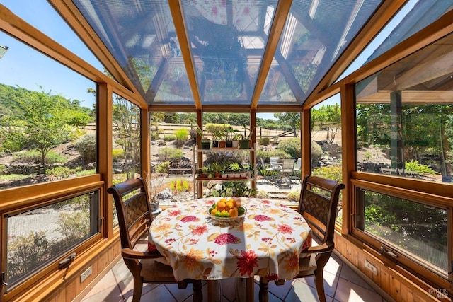sunroom / solarium featuring outdoor dining space and a healthy amount of sunlight