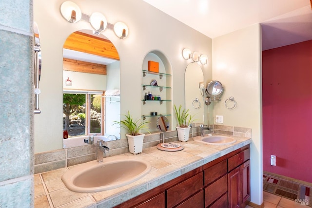 bathroom with double vanity, a sink, and built in features