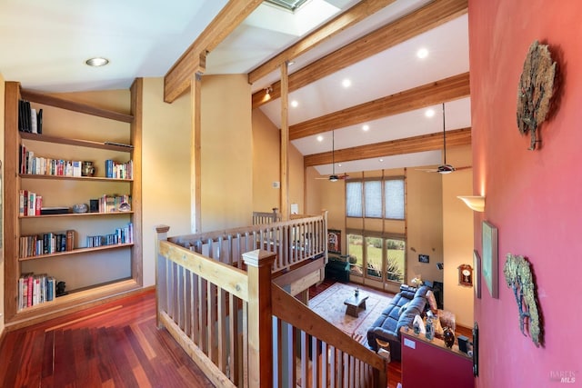 hall with high vaulted ceiling, an upstairs landing, beam ceiling, wood finished floors, and recessed lighting