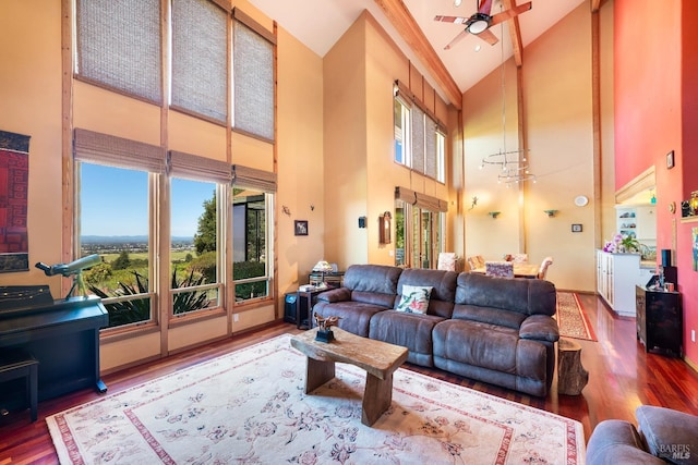 living room featuring wood finished floors, high vaulted ceiling, ceiling fan, and a wealth of natural light