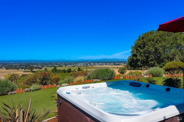 exterior space featuring a yard and a hot tub