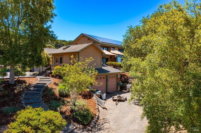 view of front of house with stairs, driveway, and an attached garage