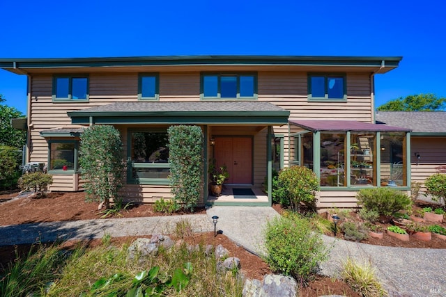 view of front facade with a sunroom
