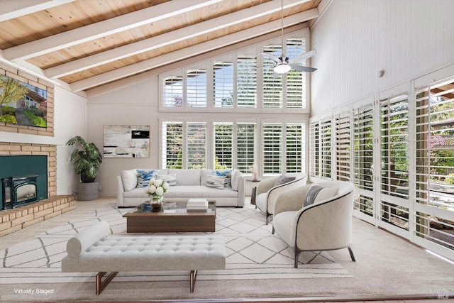 carpeted living room with a ceiling fan, wood ceiling, beam ceiling, and high vaulted ceiling