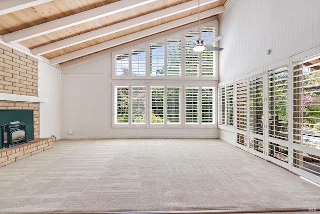 unfurnished living room featuring carpet flooring, ceiling fan, and beamed ceiling