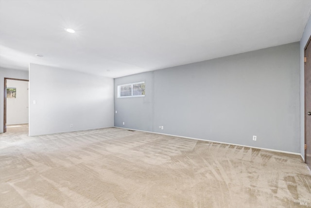 unfurnished room featuring light carpet, baseboards, and recessed lighting