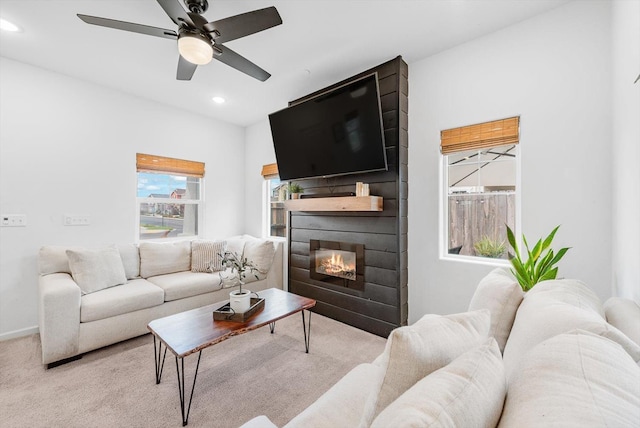living room featuring carpet floors, a fireplace, baseboards, ceiling fan, and recessed lighting