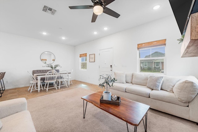 living area with recessed lighting, visible vents, and a healthy amount of sunlight