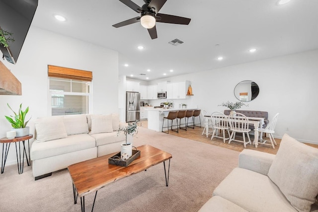 living room with recessed lighting, ceiling fan, and visible vents