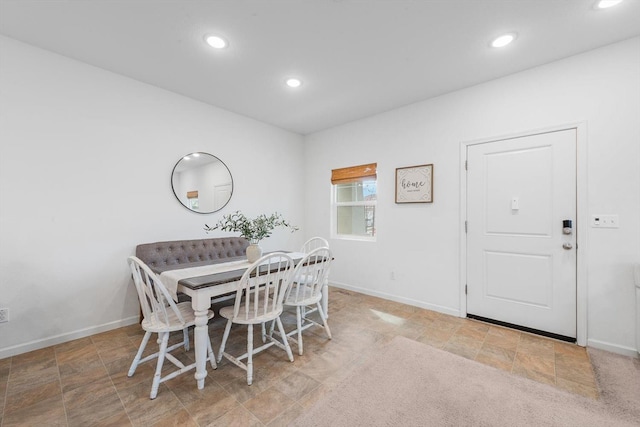 dining space featuring baseboards, stone finish floor, and recessed lighting
