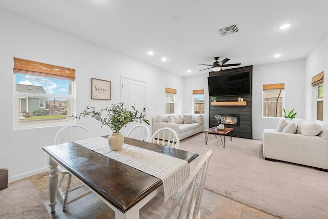 dining area with ceiling fan, a fireplace, recessed lighting, baseboards, and visible vents