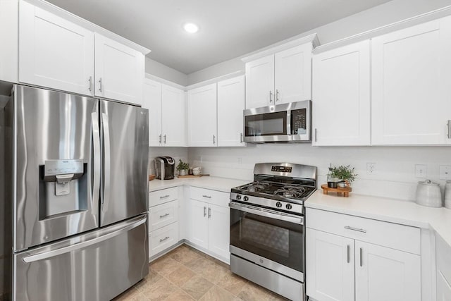 kitchen featuring recessed lighting, light countertops, white cabinets, and stainless steel appliances