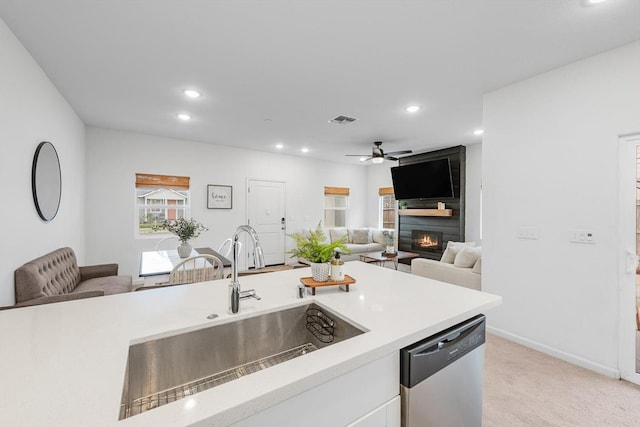 kitchen with a sink, stainless steel dishwasher, open floor plan, and visible vents