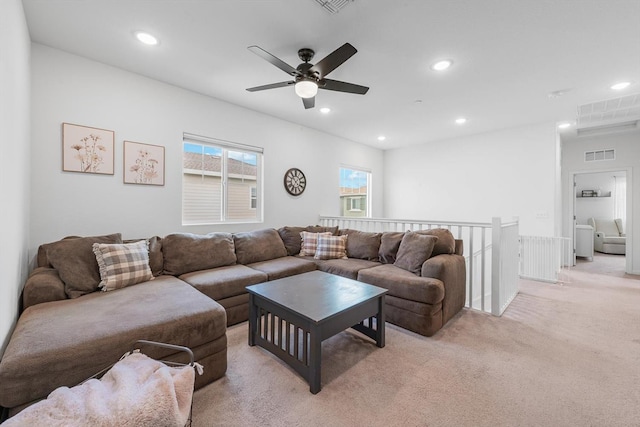 living area featuring light colored carpet, a ceiling fan, visible vents, and recessed lighting