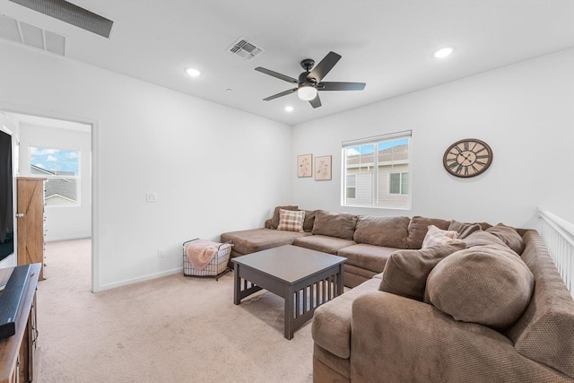 living area featuring recessed lighting, ceiling fan, visible vents, and light carpet