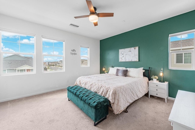 bedroom featuring baseboards, visible vents, ceiling fan, and carpet