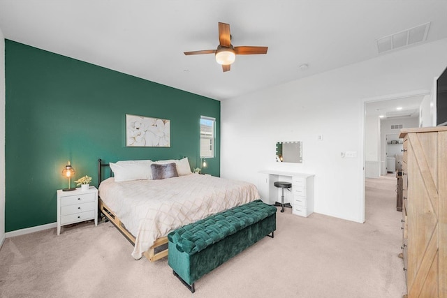 bedroom featuring an accent wall, carpet, a ceiling fan, and visible vents