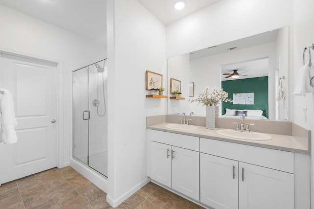 ensuite bathroom with a sink, a ceiling fan, ensuite bath, and a shower stall