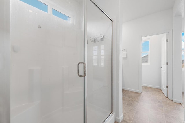 full bathroom with baseboards and a shower stall