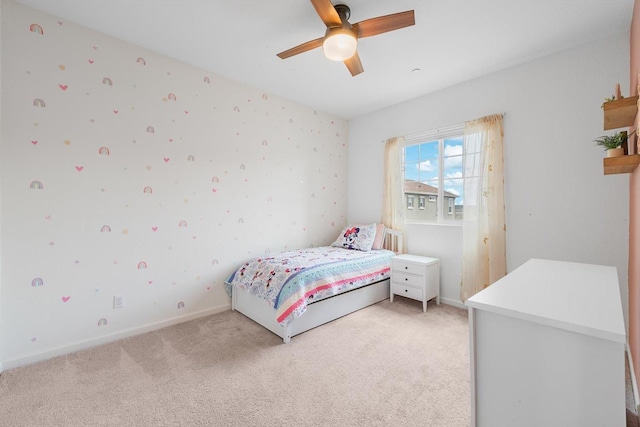 bedroom featuring baseboards, a ceiling fan, and light colored carpet
