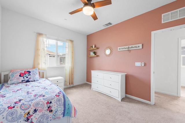 bedroom with baseboards, light colored carpet, and visible vents