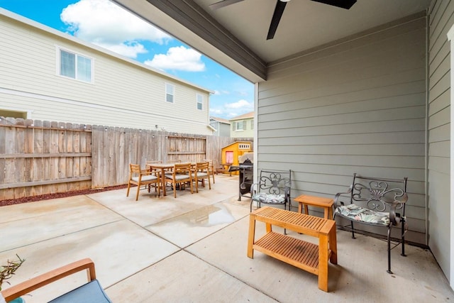 view of patio / terrace with ceiling fan, fence, and outdoor dining area