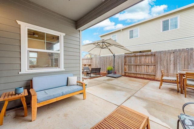 view of patio featuring fence and outdoor dining space
