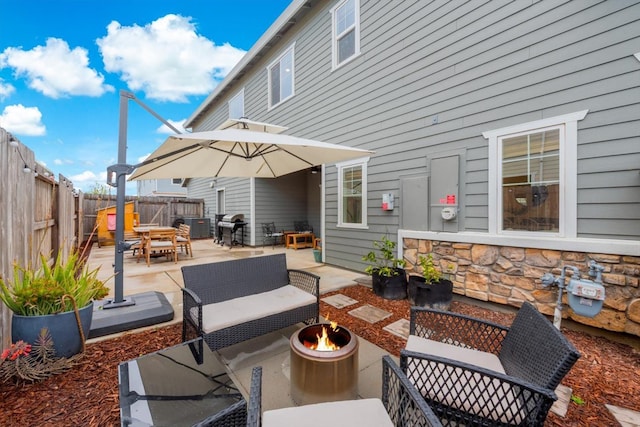 view of patio / terrace with a fenced backyard, an outdoor fire pit, area for grilling, and outdoor dining space