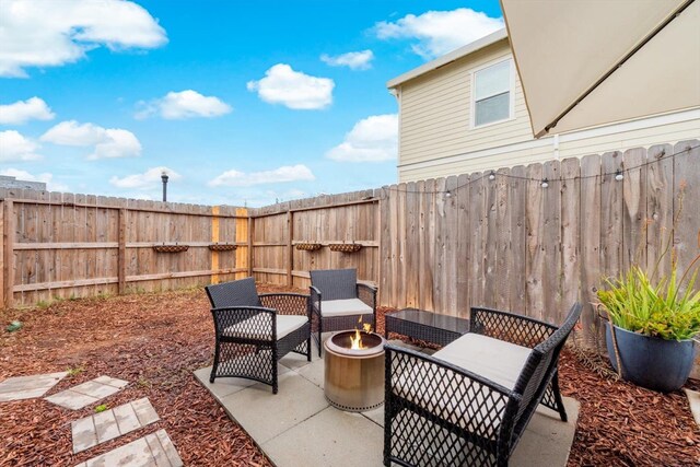 view of patio / terrace with fence and a fire pit