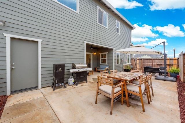view of patio / terrace with fence, grilling area, and outdoor dining space