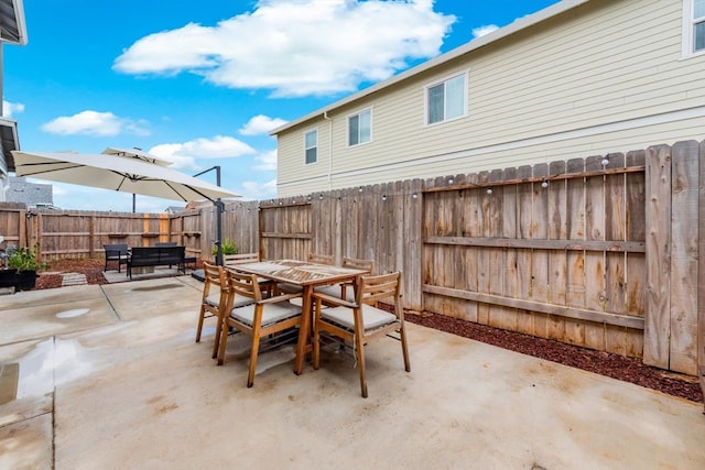 view of patio / terrace with outdoor dining space and a fenced backyard