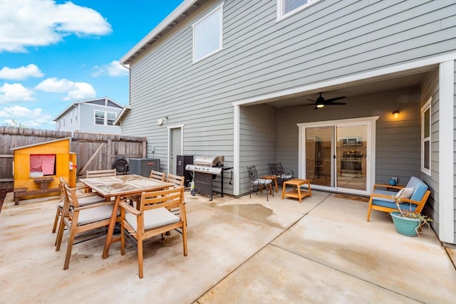 view of patio / terrace with area for grilling, ceiling fan, fence, and outdoor dining area