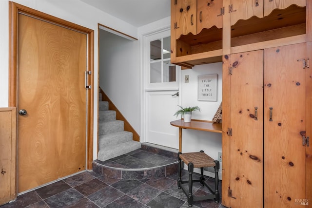 interior space featuring stone tile flooring and stairs