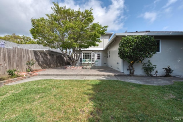 view of yard with fence and a patio area